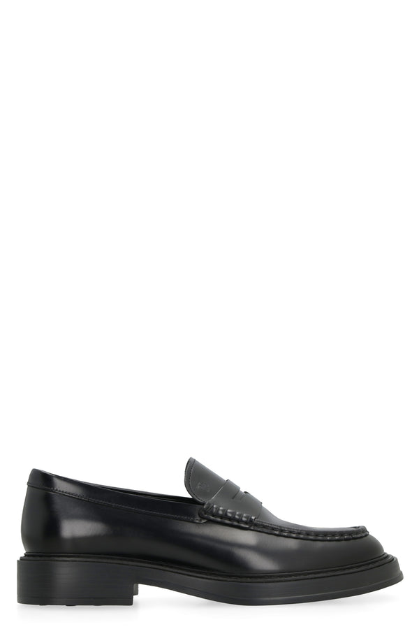 Tod's Tod's Black Full Grain Leather Loafers.  Tod's Monogram Embossed On Front.  Exposed Hand-Stitched Seams.  Leather Piping.  Extra-Light Gum Sole With Distinctive Gommini On Base.  Made In Ital