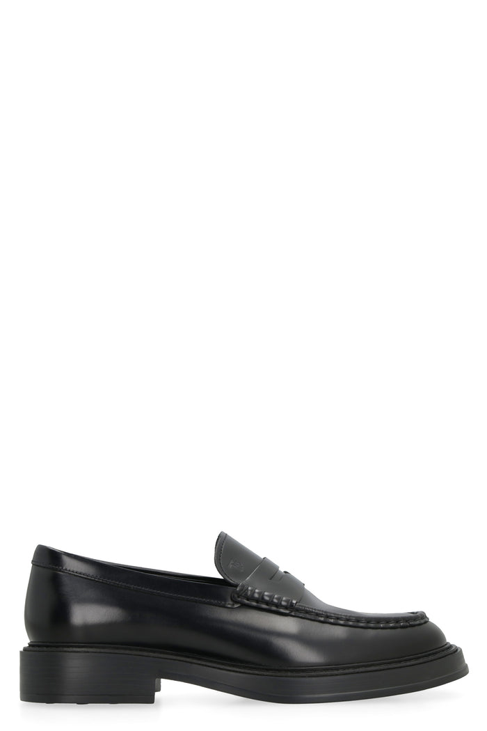 Tod's Tod's Black Full Grain Leather Loafers.  Tod's Monogram Embossed On Front.  Exposed Hand-Stitched Seams.  Leather Piping.  Extra-Light Gum Sole With Distinctive Gommini On Base.  Made In Ital